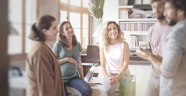 Ein Betriebspsychologe berät das Team einer Arbeitsabteilung im Büro.